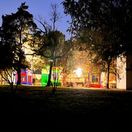 Bounce houses set up throughout forest.