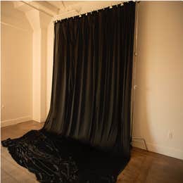 Black flowing fabric drape backdrop 