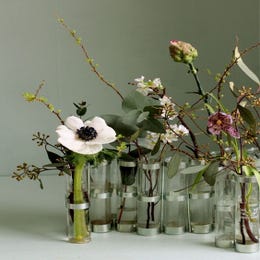 Set of decorative table flowers in glass jars