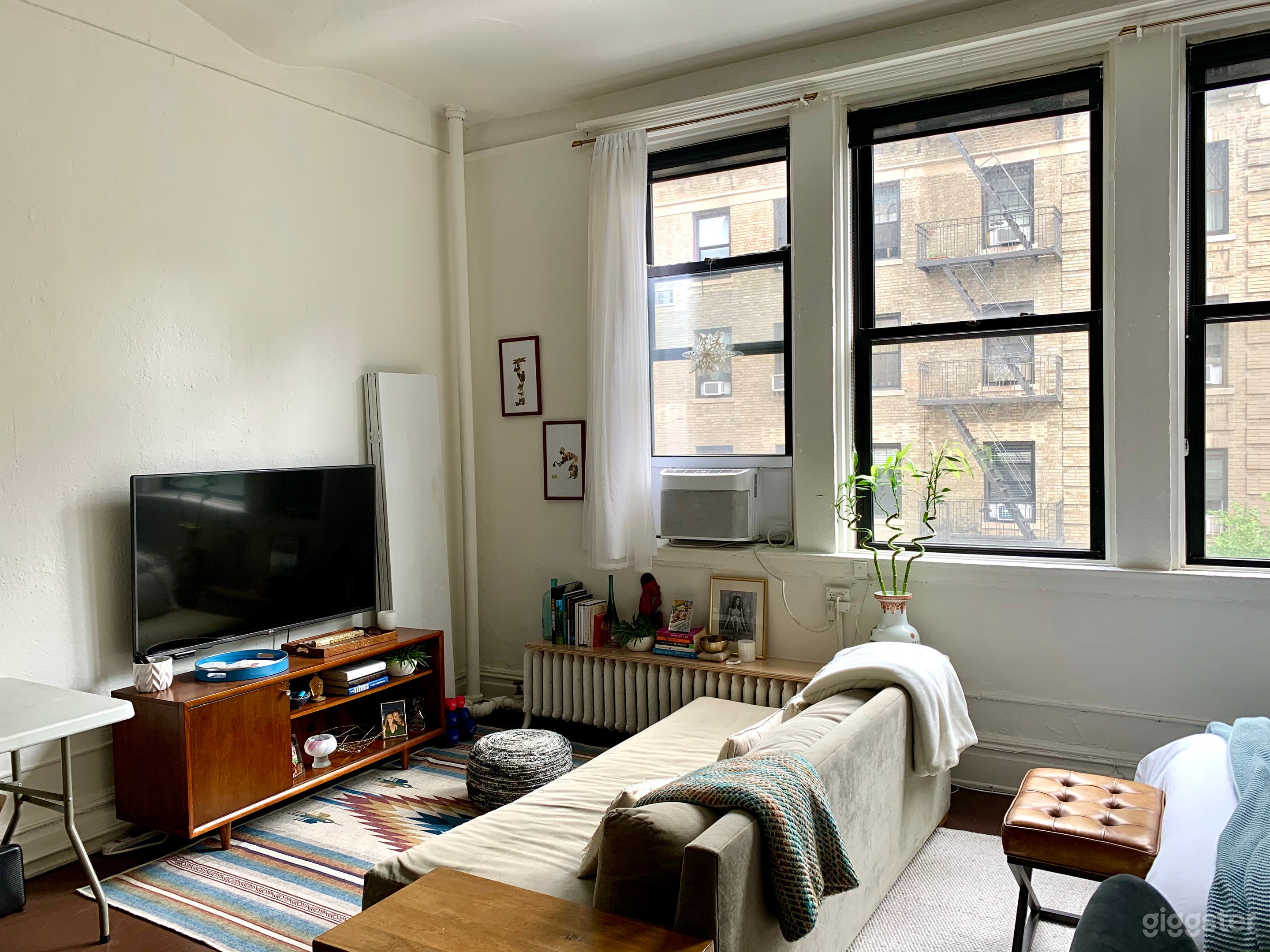 TV is mounted to wall and is on a rotating arm.