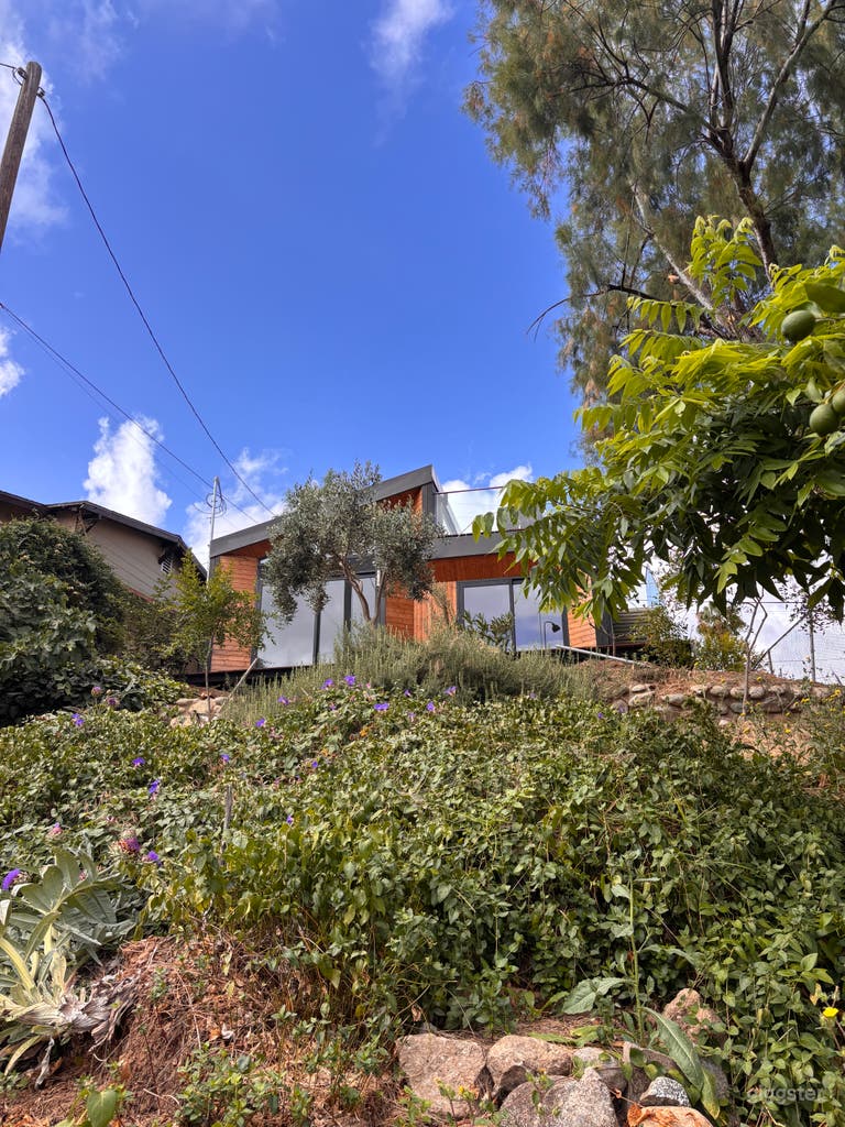  Warm modern exterior surrounded by lush hillside landscaping, wood accents, clean architectural lines, and bright California light—ideal for film, TV, photo shoots, Conveniently located by York blvd in highland park 