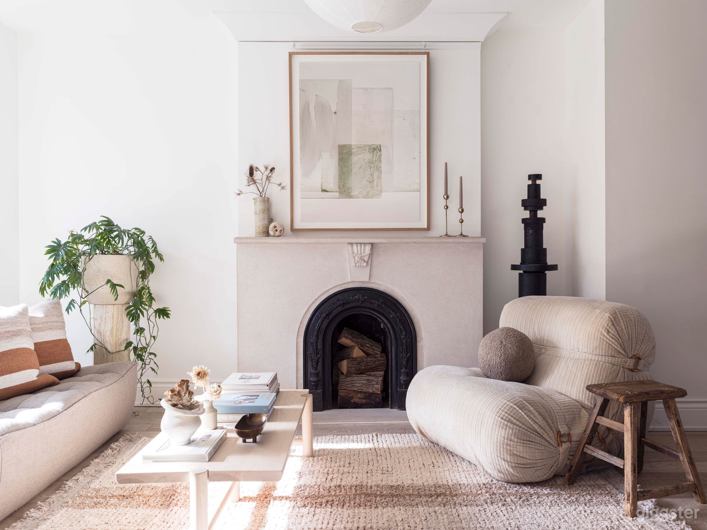 Living Room. Victorian charm with modern / Scandinavian furniture and aesthetics. Neutral interior. White walls. Custom designed fireplace with mantle. White oak floors.