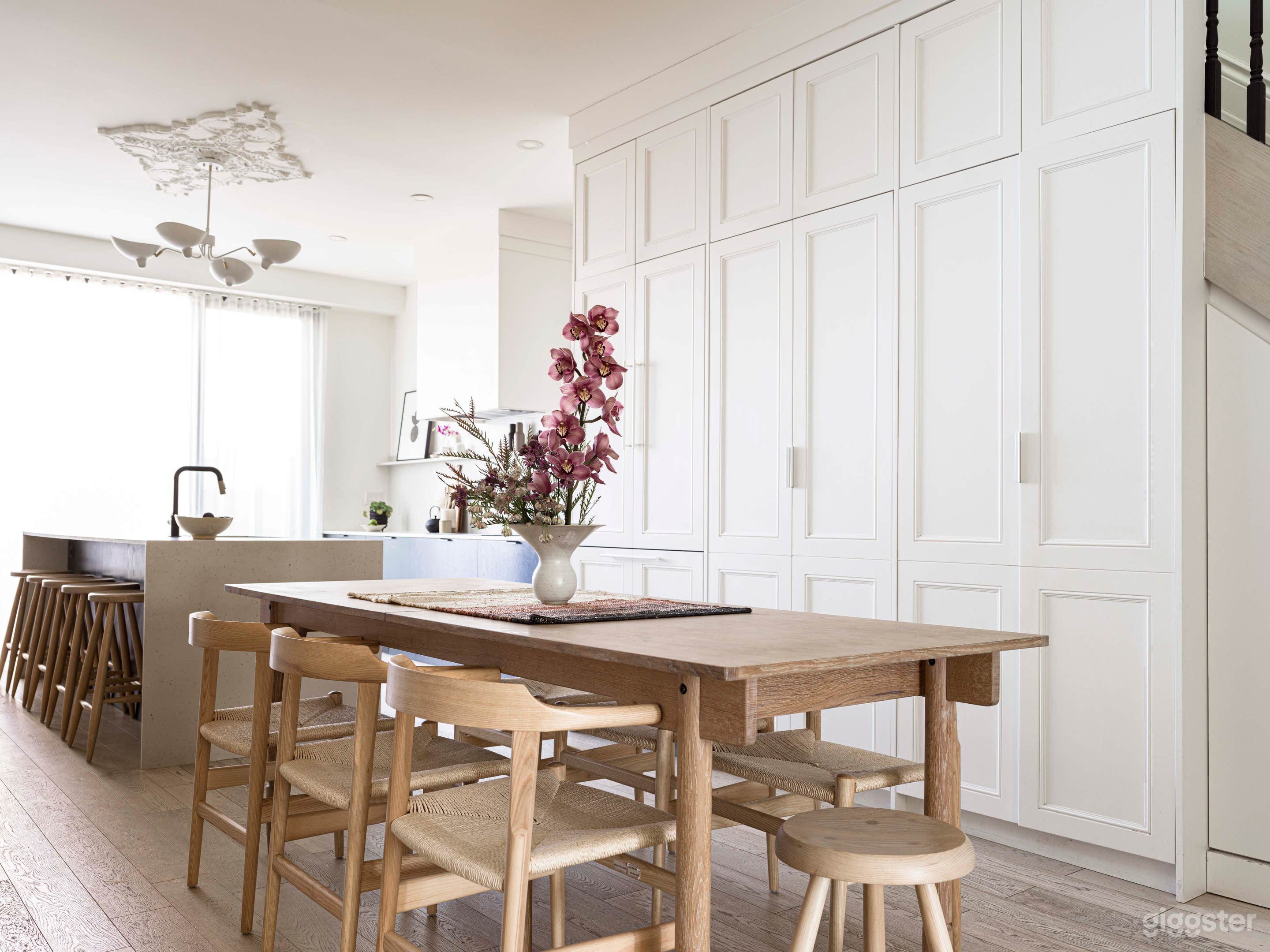 Dining Room, open plan kitchen with hidden pantry and appliances. White oak floor and furnishings.