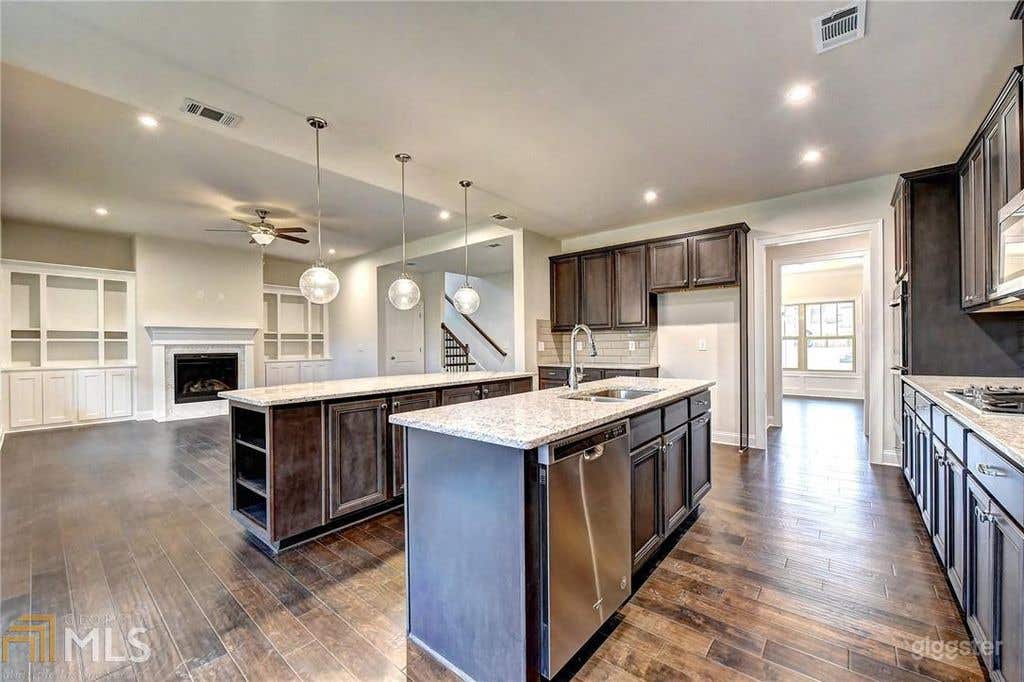 Double Island Kitchen into Family Room From Breakfast Nook Area