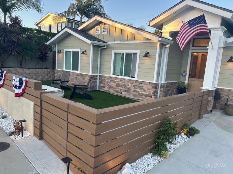  Front yard that welcomes but is functional with gas fire pit, Adirondack chairs, flat driveway, side gated entrance for production equipment and grips. 
