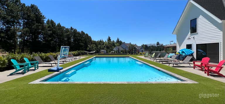  50x24 salt water swimming pool with large pool deck and turf for yard games. 