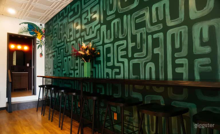  Handcrafted bar tables invite conversation. Bespoke art wall makes a picture-perfect moment.  