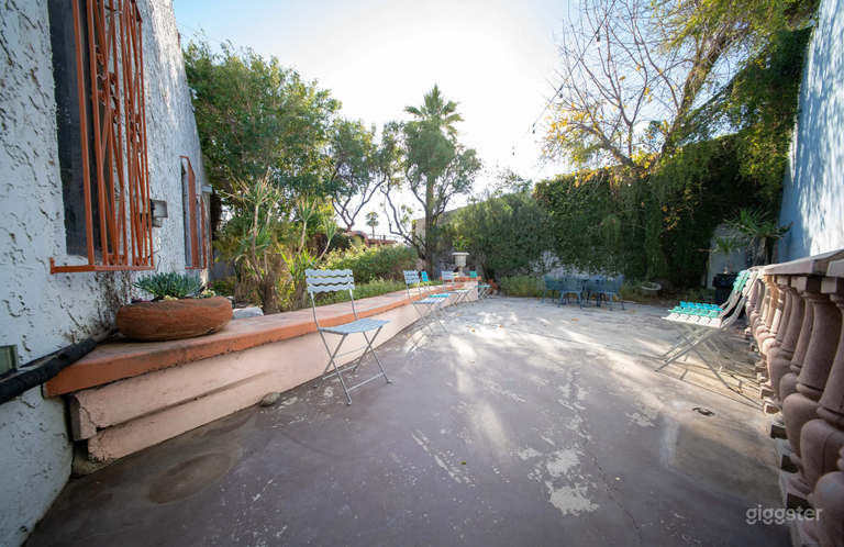  Oasis | Outdoor Studio Space: Lush greenery, rustic accents, stone pathways, string lights, versatile layouts for various shoots. 