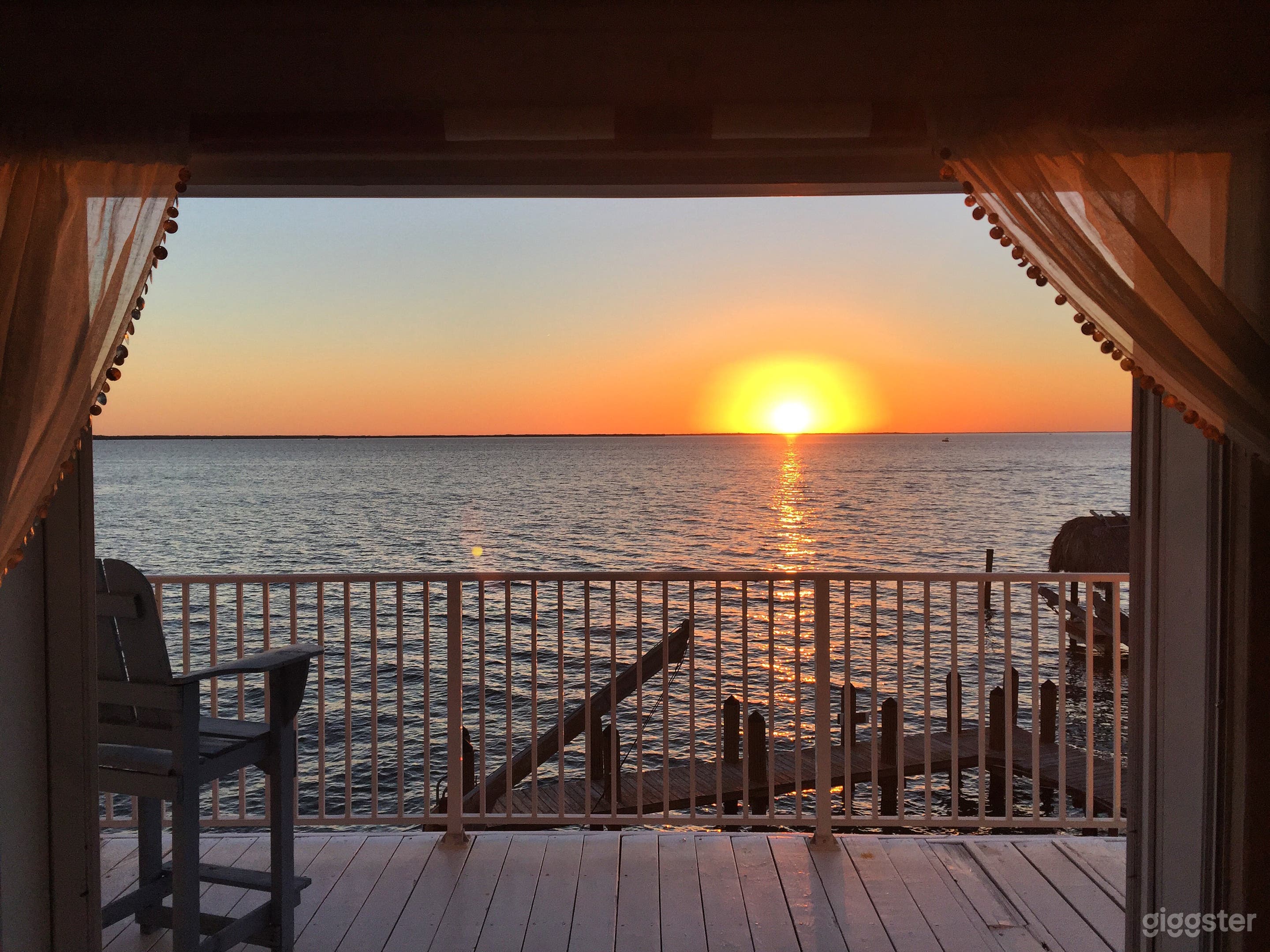 Gorgeous sunset and waterfront water views from living room.  Views from master balcony, pool &amp; terrace areas as well. 