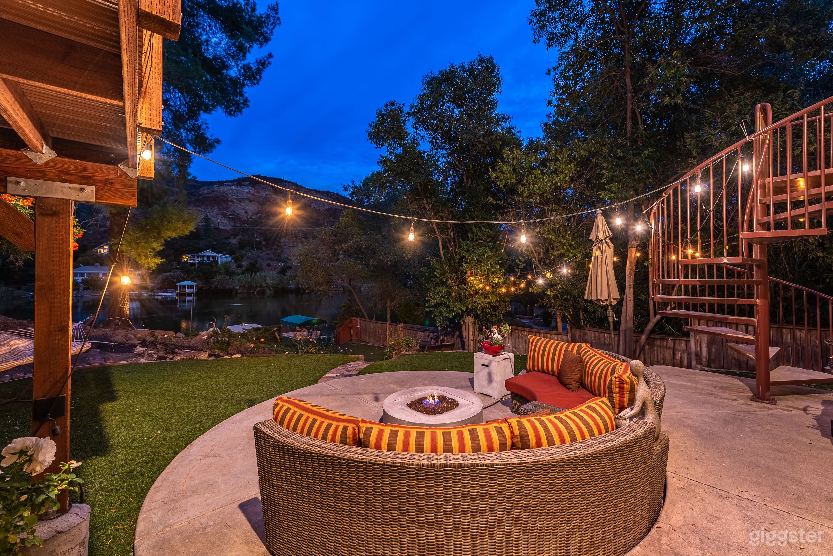 Circular patio with fire-pit, facing the water.