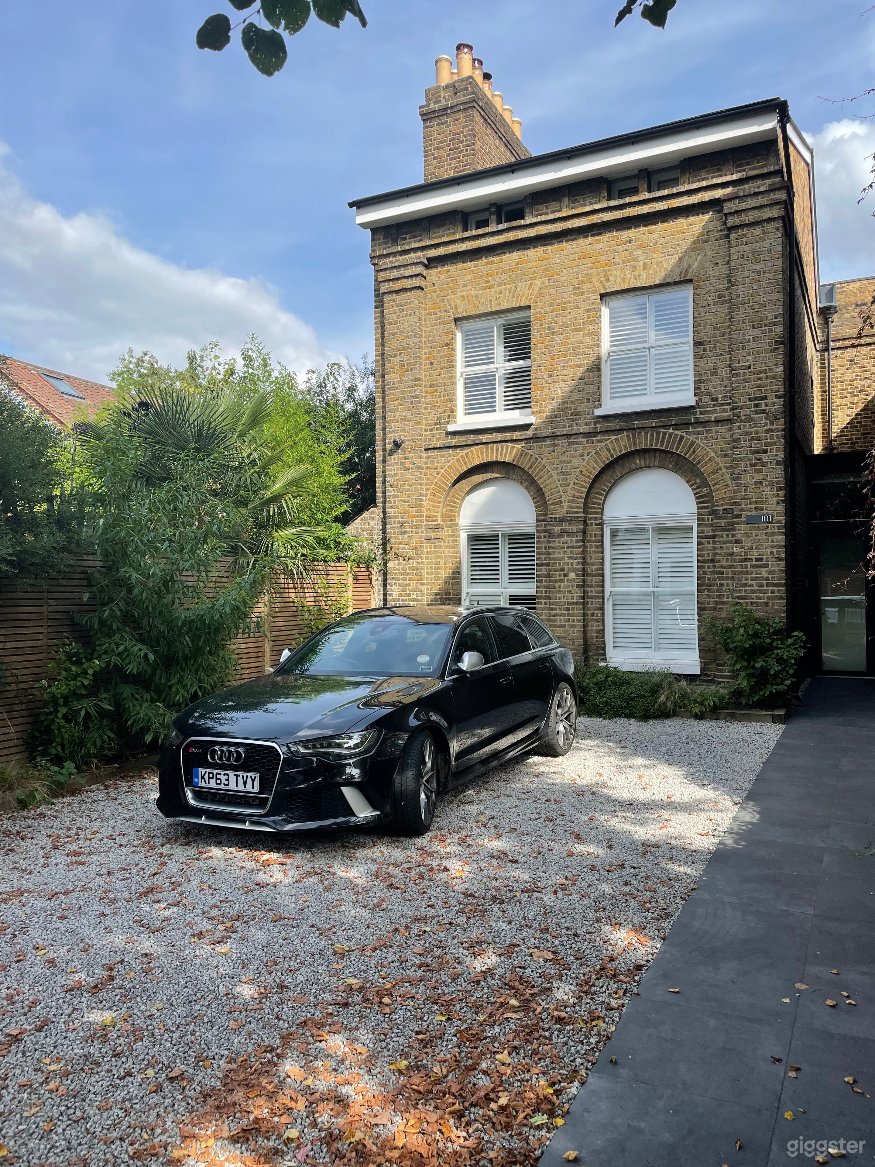 Front of property - driveway and glass entrance door to the right 