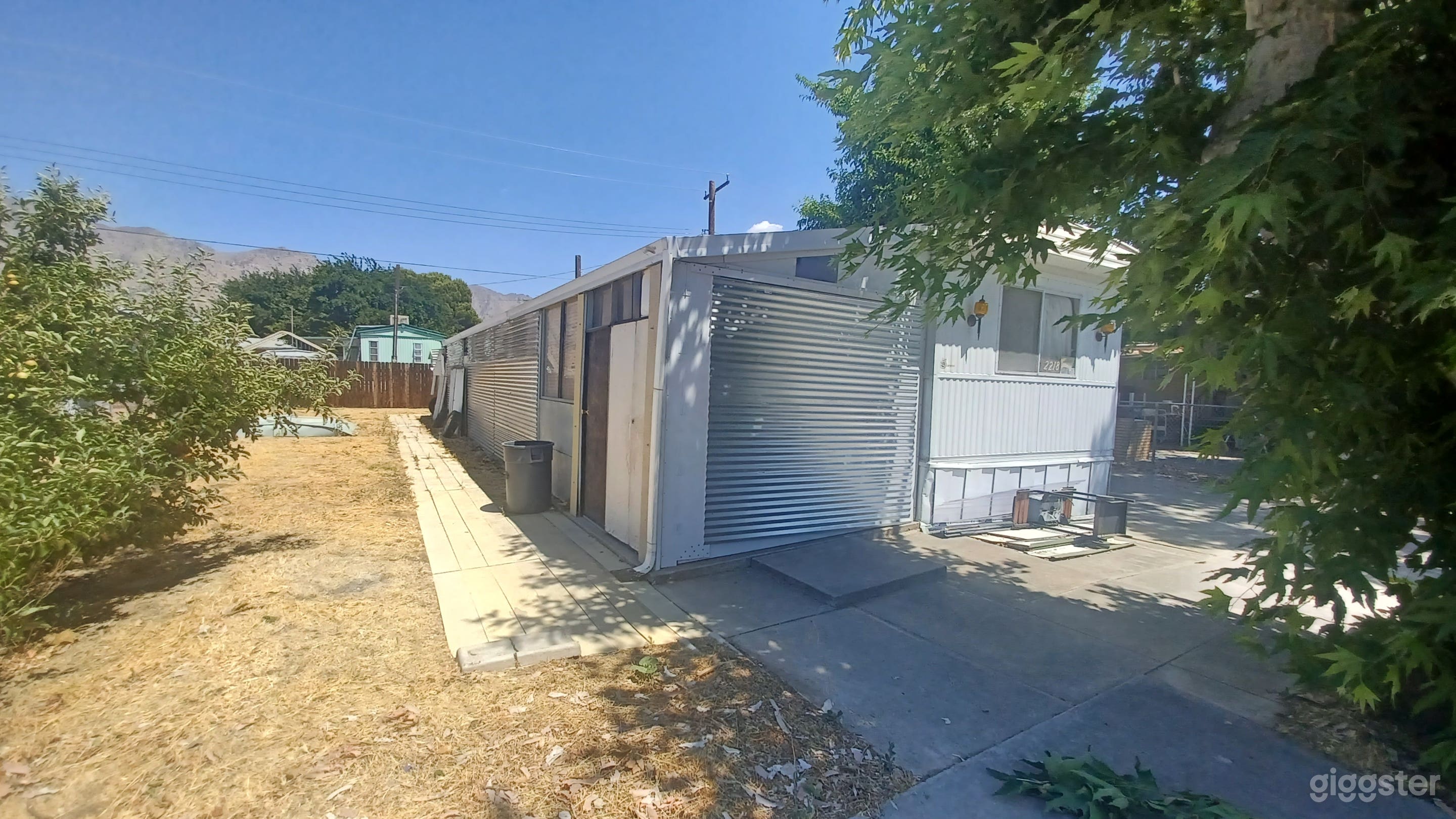 Street view showing the enclosed side patio and mountains landscape