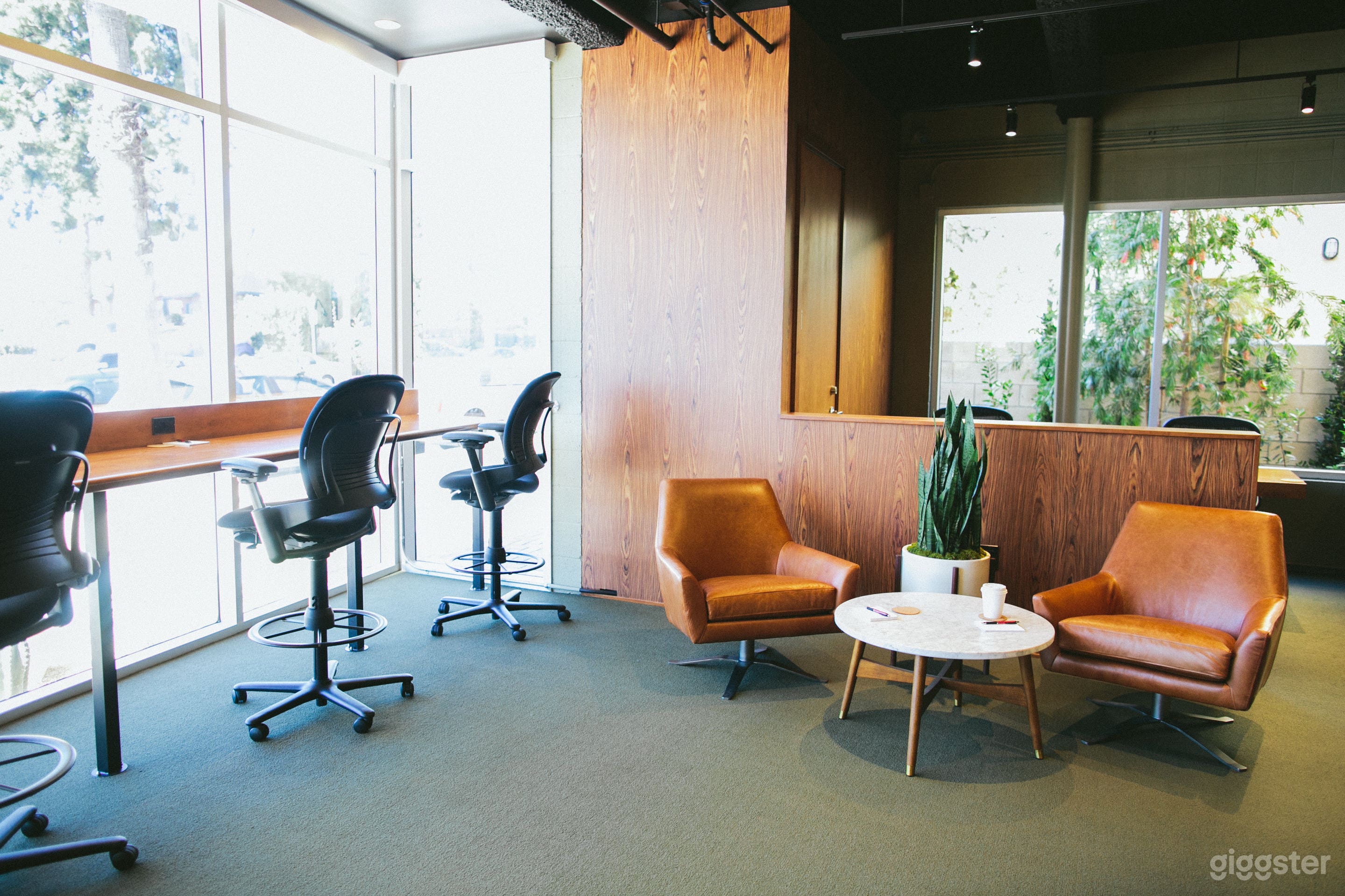 Window facing desks and first lounge area