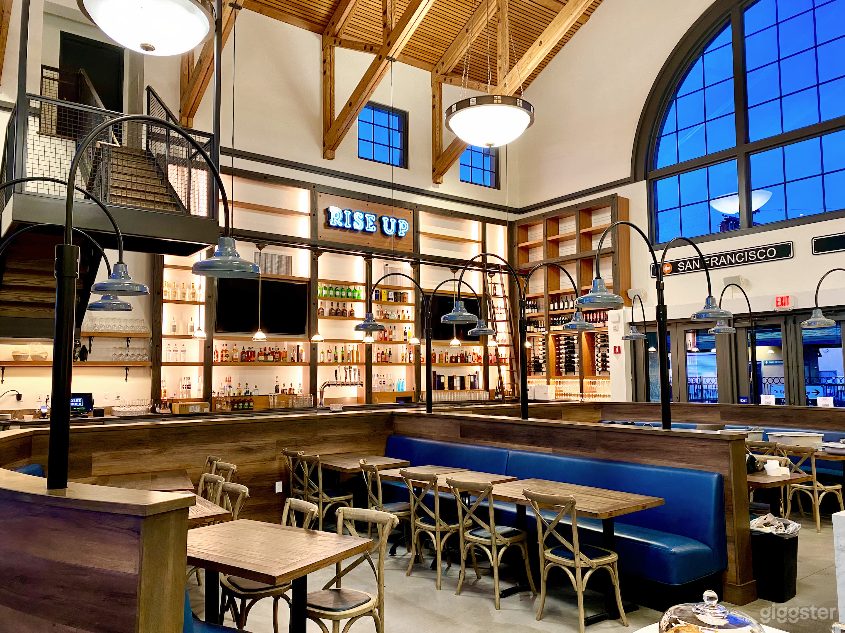 Grand main dining room located in a historic train station next to Caltrain. High ceilings, full bar with long marble top, rustic and industrial chic touches, rotisserie oven, and two imported Italian pizza ovens as the beating heart of the restaurant.