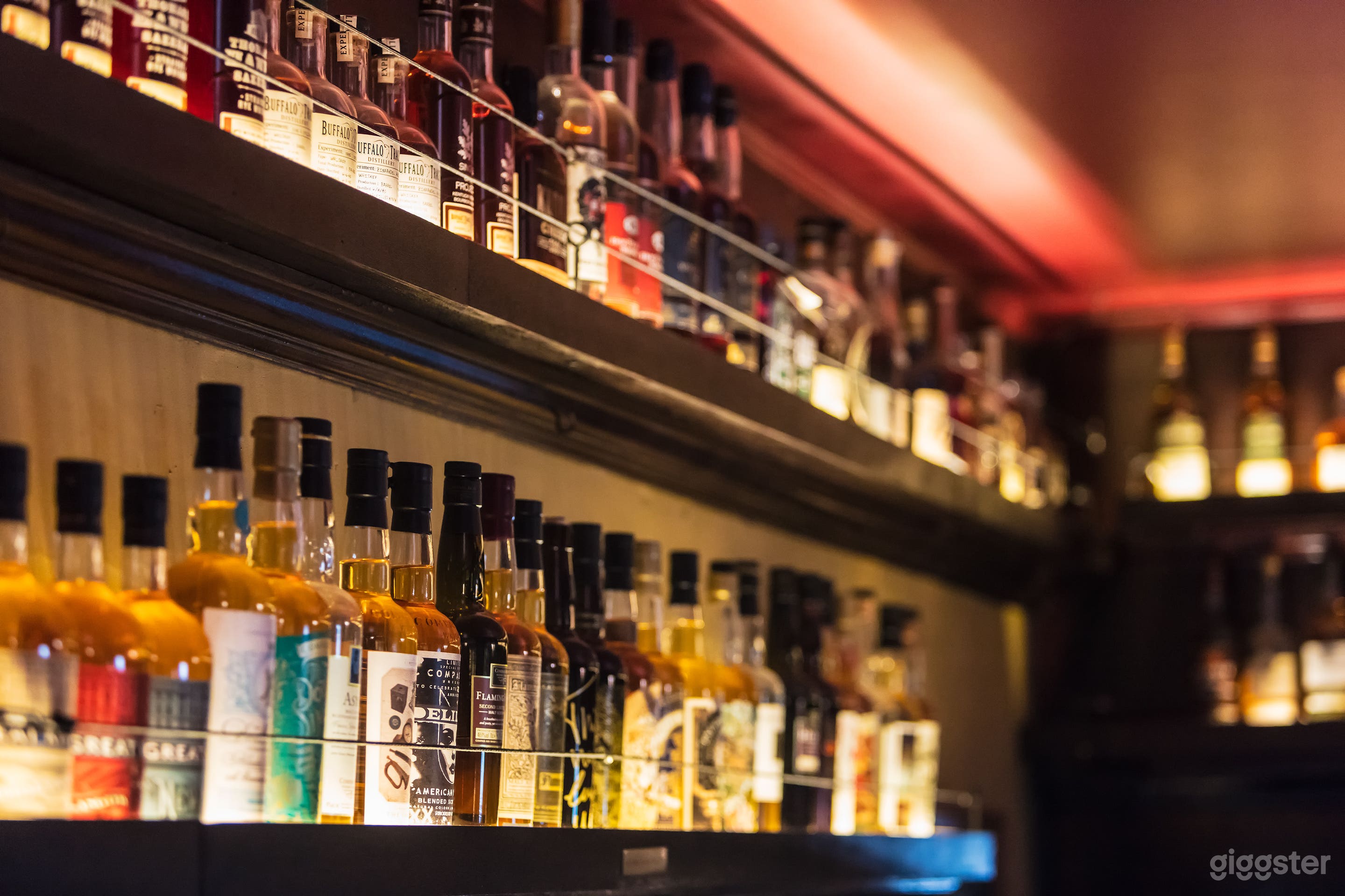 whiskey shelves line the bar on all sides