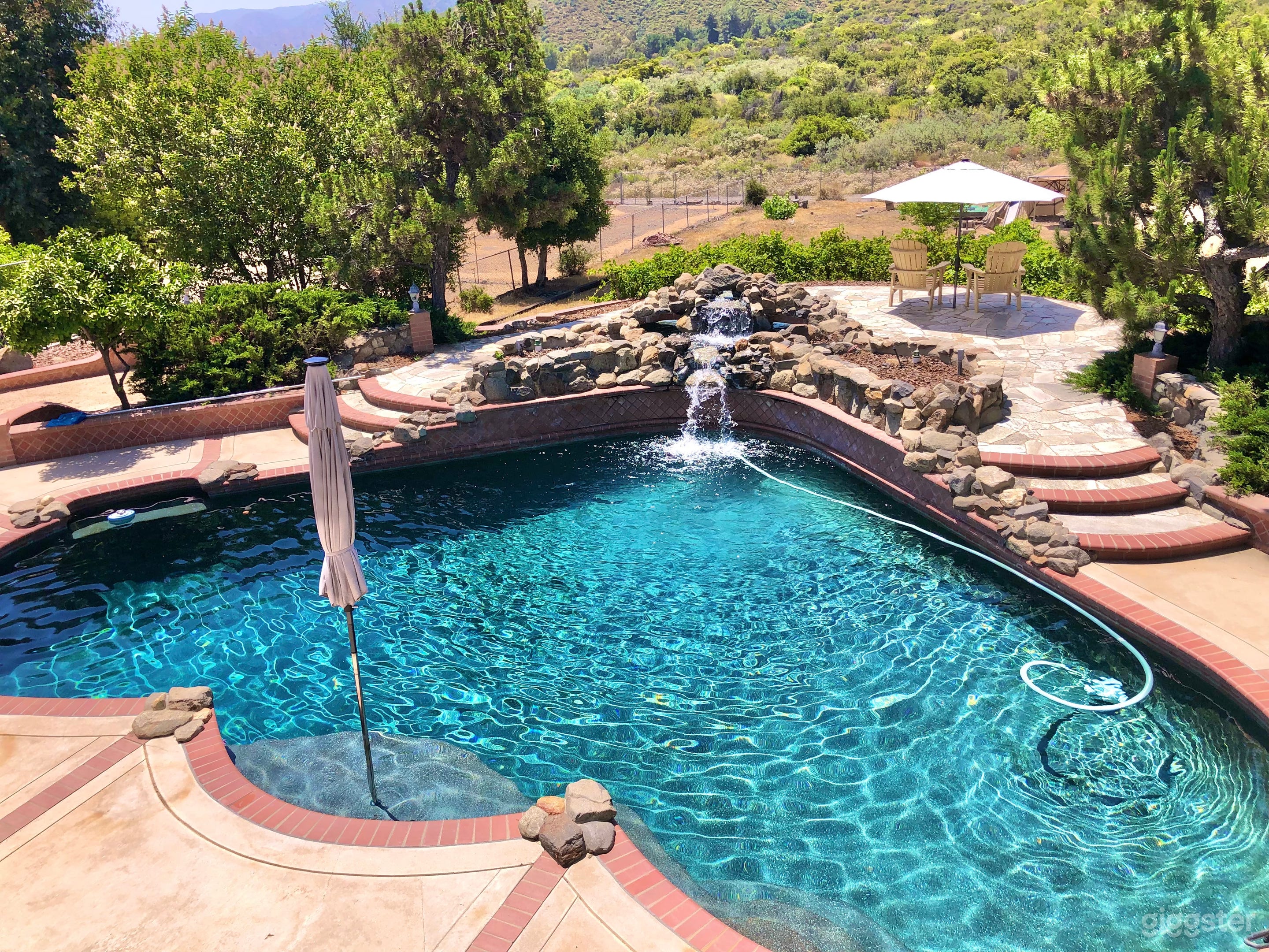 Secluded pool with rock waterfall Photo 3