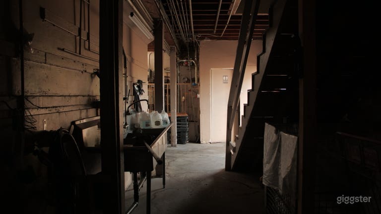  Back interior - backroom storage retail space. Stairs to second floor with offices and wifi. (offices overlook main interior: security guard offices) 