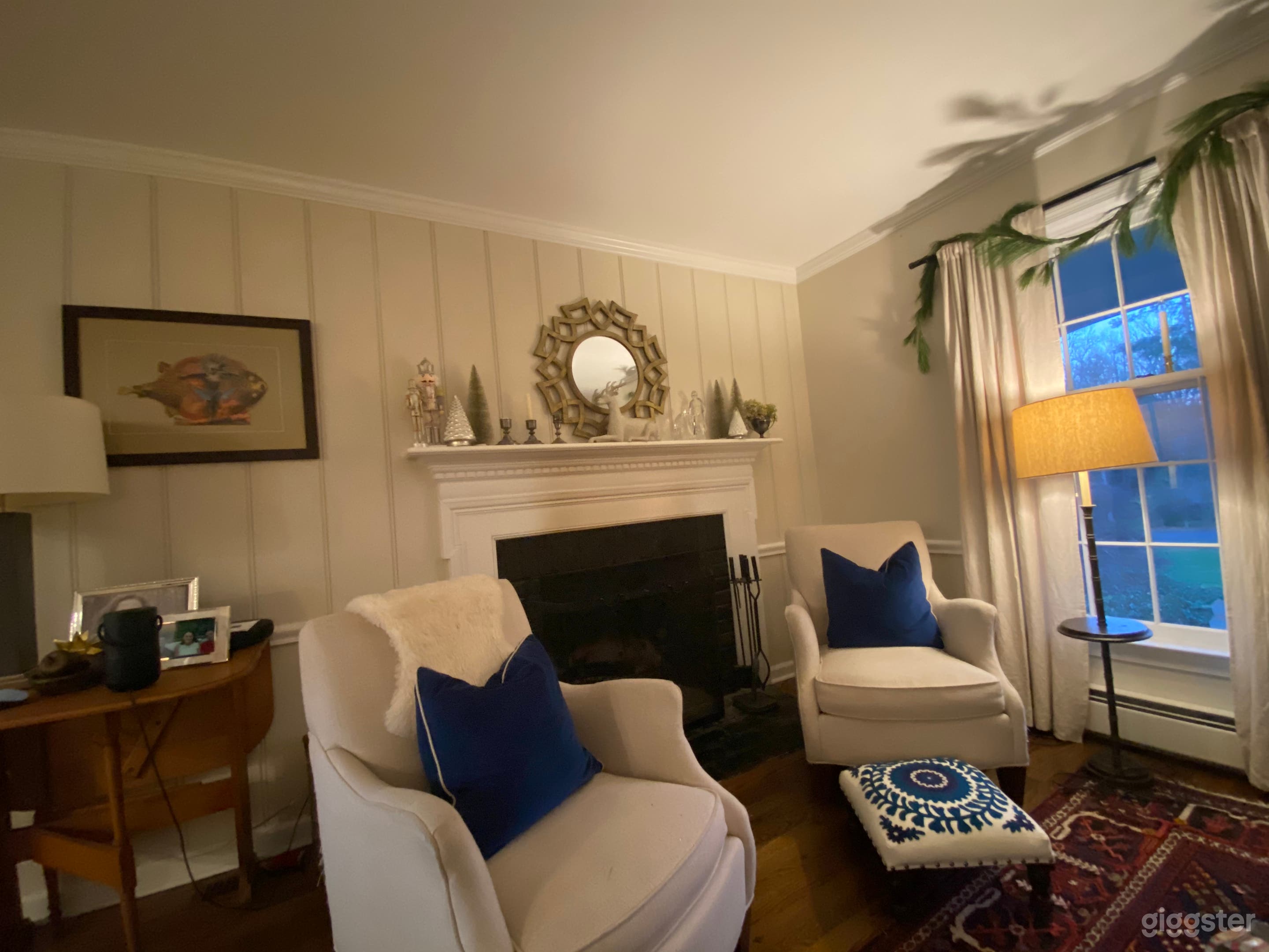 Inviting living room; wood burning fireplace with mantle and floor to ceiling windows