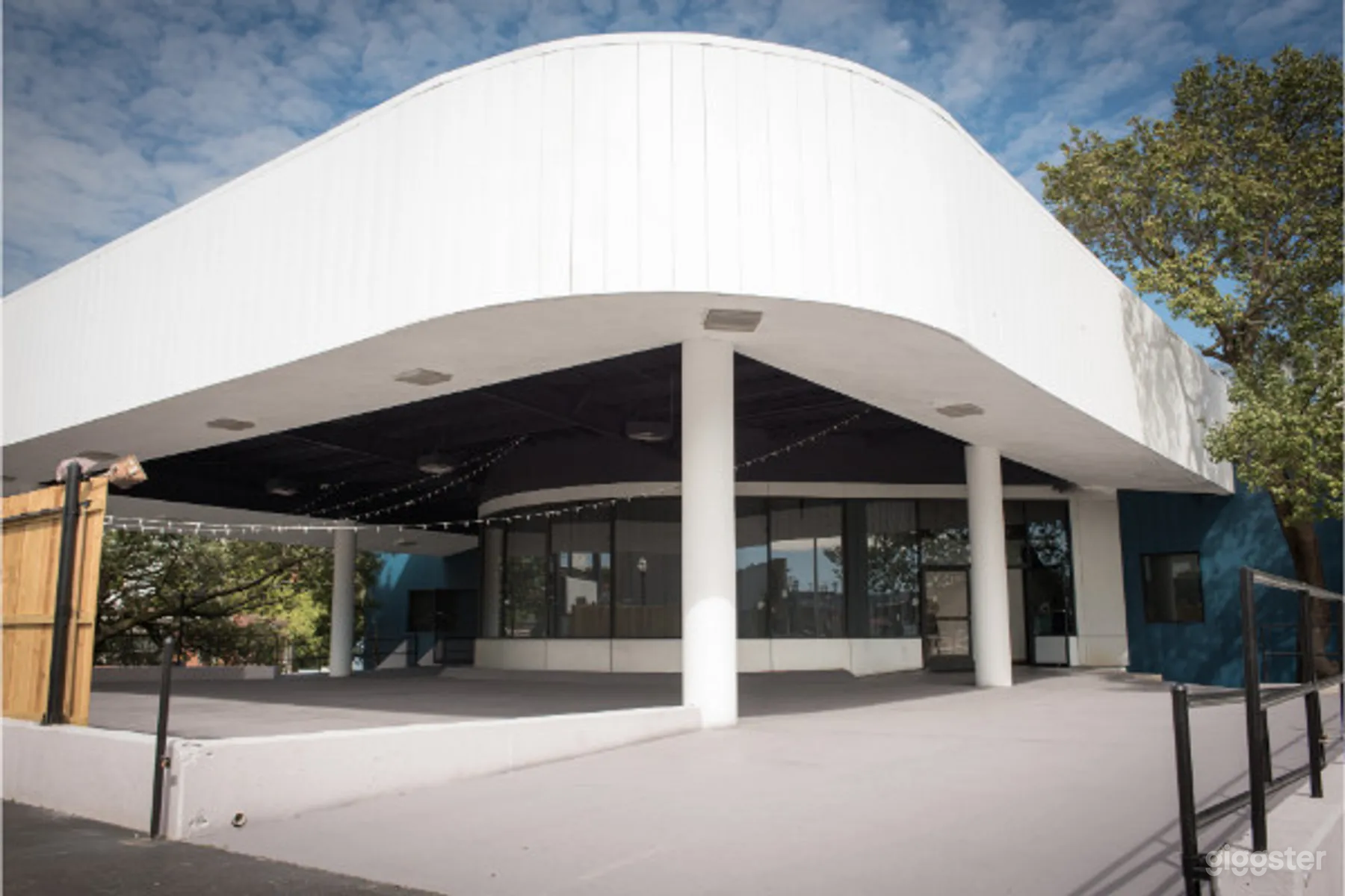 Streetview of the building, showcasing the covered patio &amp; building's art deco design
