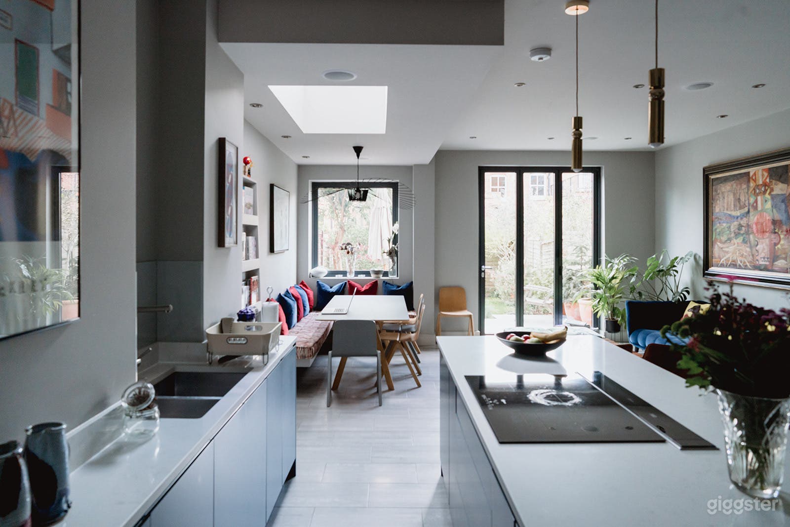 Kitchen open space with dining and sitting area view and bifold doors.