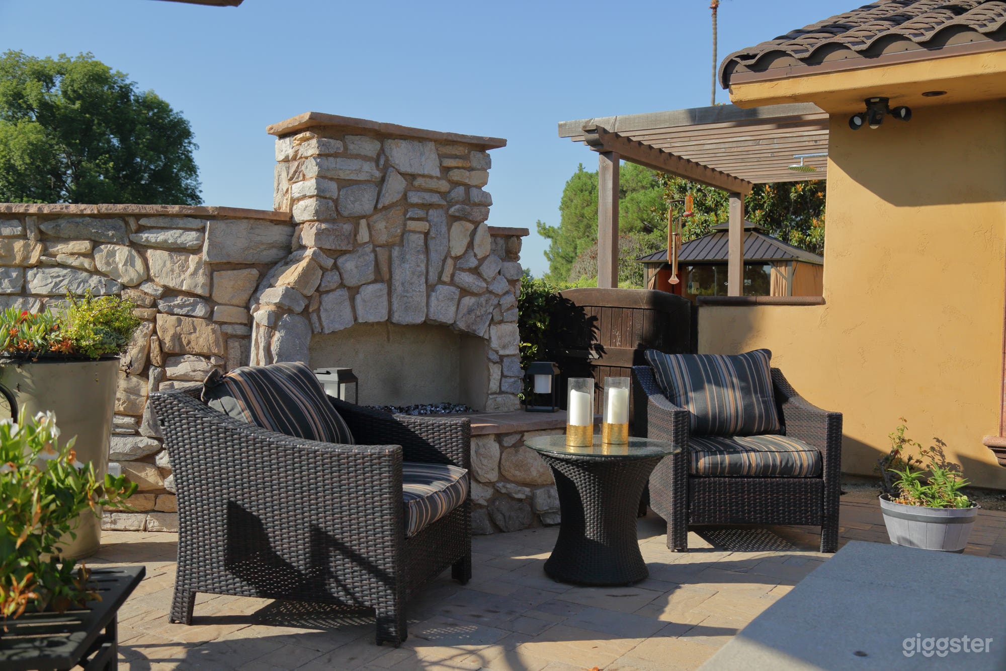 Large outdoor fire place looking out at pool and golf course view