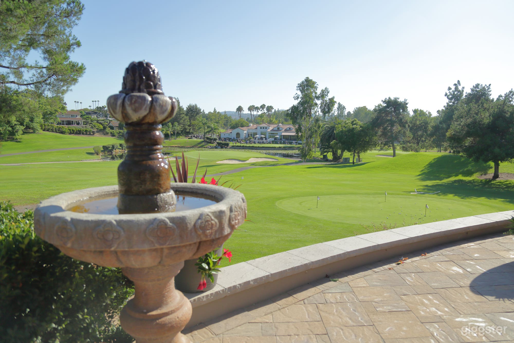 View of beautiful Country Club, pond with two fountains, panoramic golf course view