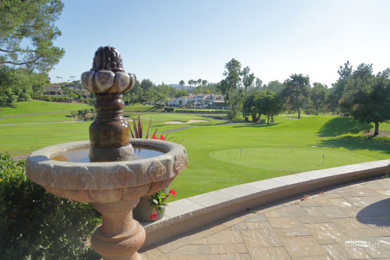  View of beautiful Country Club, pond with two fountains, panoramic golf course view 