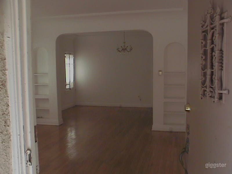 Unfurnish version of front door, enter living room, to dining room. Built in arch and bookcases. Origonal hardwood floors from the 1927'ish