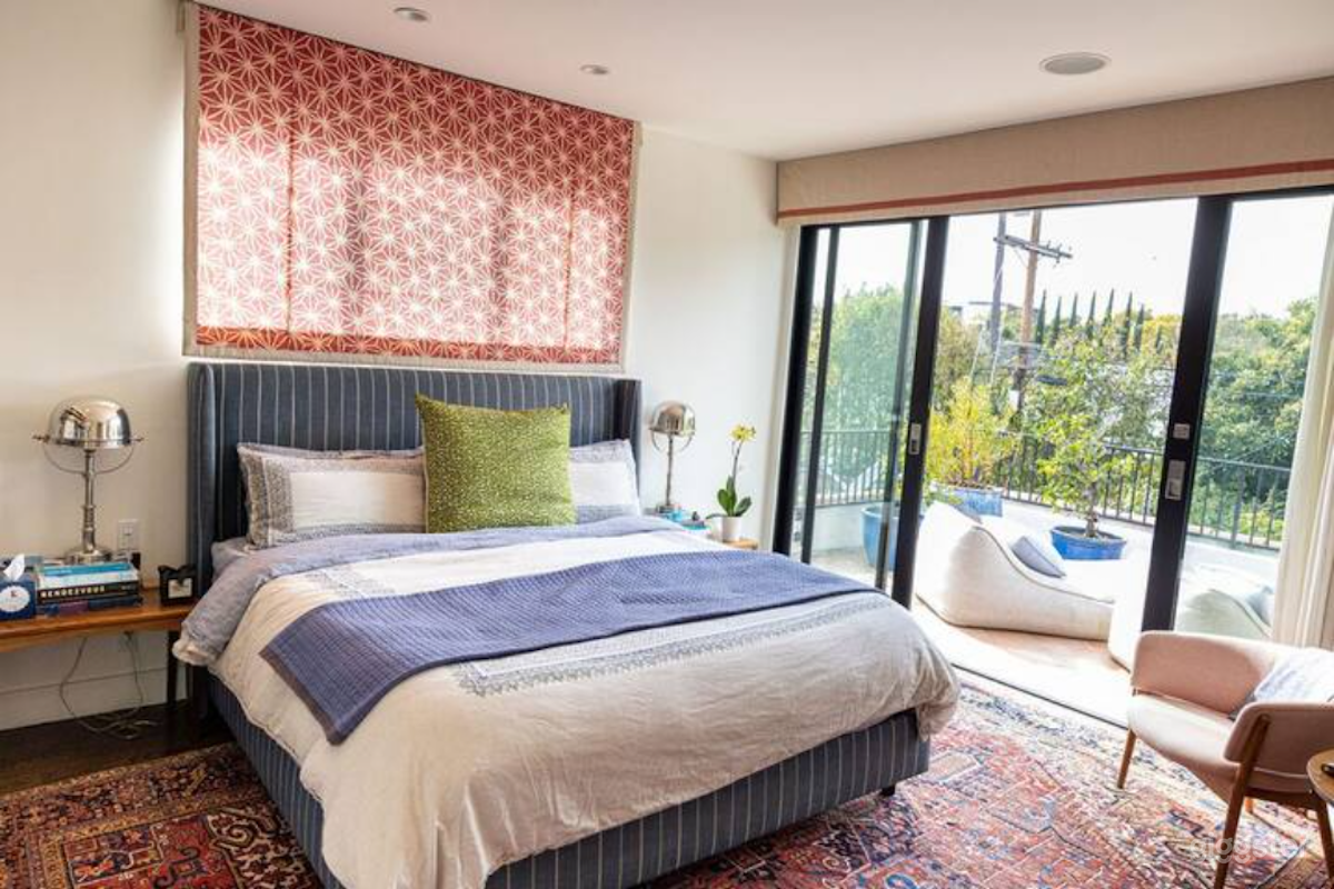 Primary EnSuite Bedroom, with King bed, seating and balcony overlooking back yard.