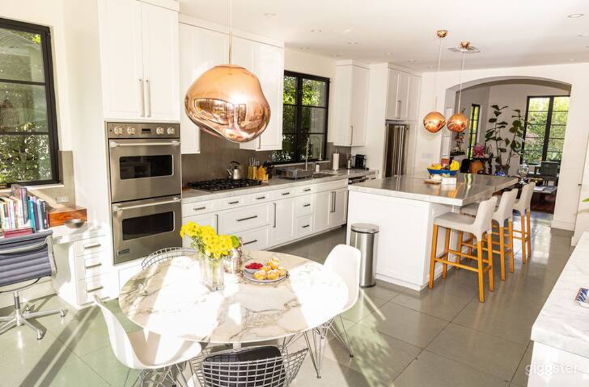 Kitchen with marble countertops, island, dining area