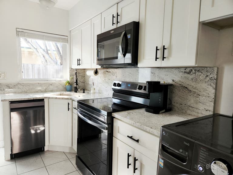  White kitchen with black stainless steel appliances 