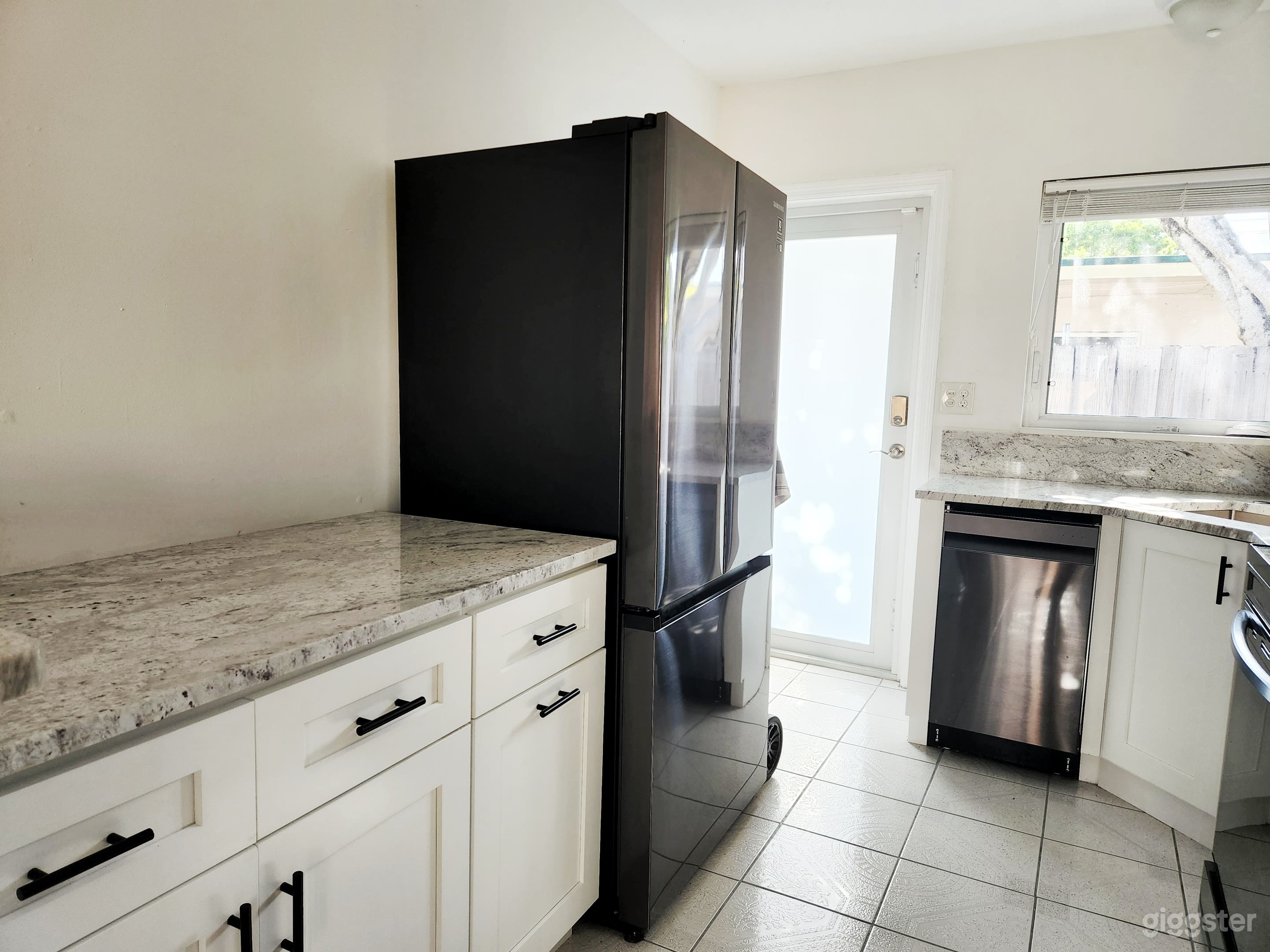 White kitchen with black stainless steel appliances