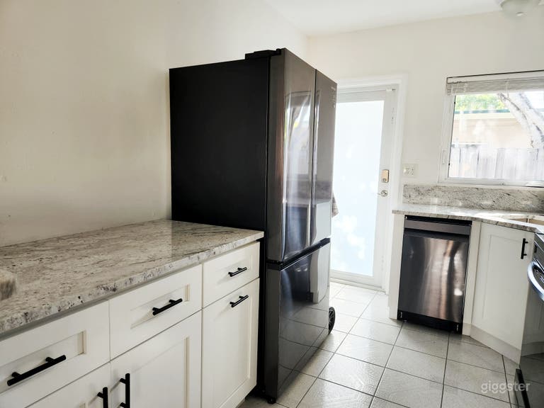  White kitchen with black stainless steel appliances 