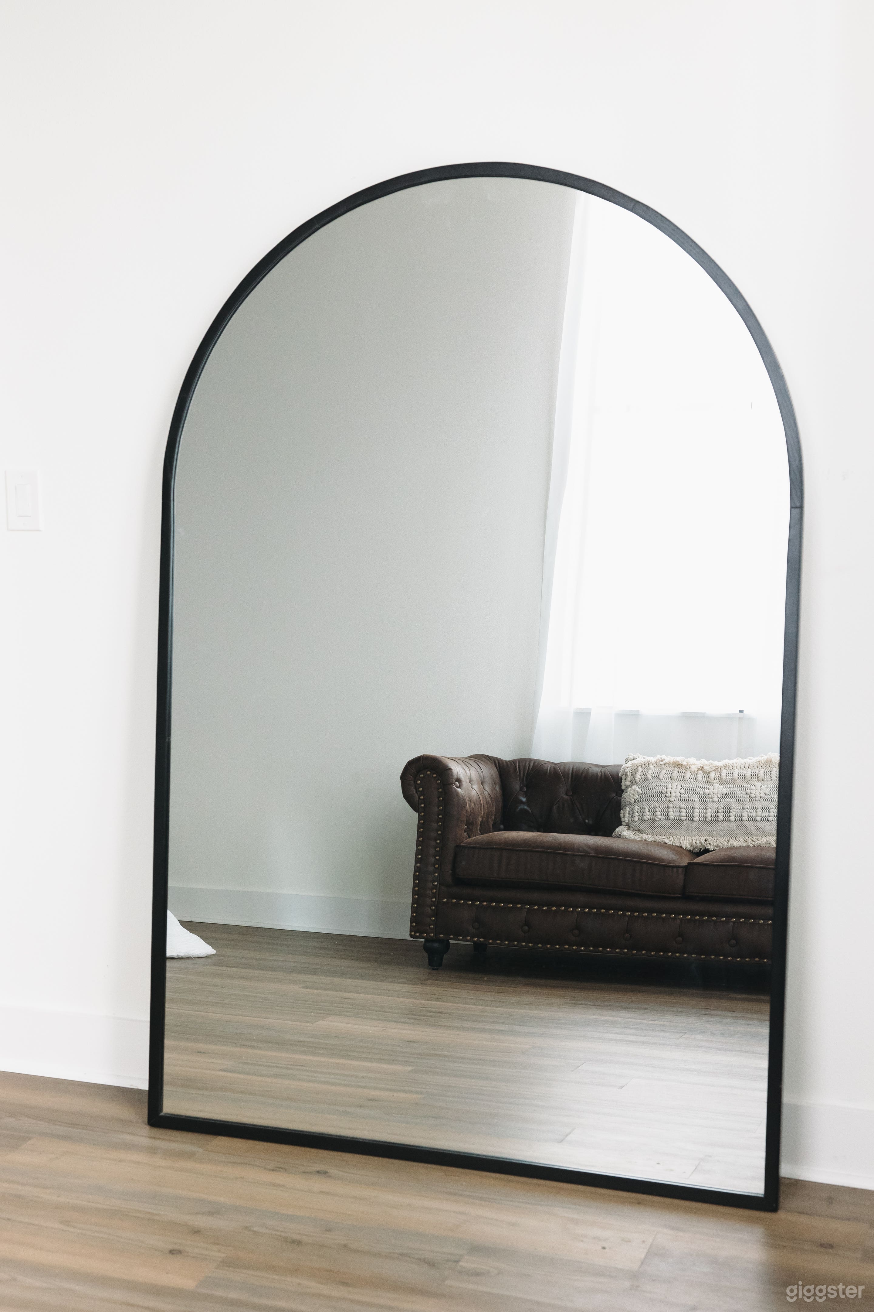 Large Mirror in our Lifestyle loft room with a bed and leather couch
