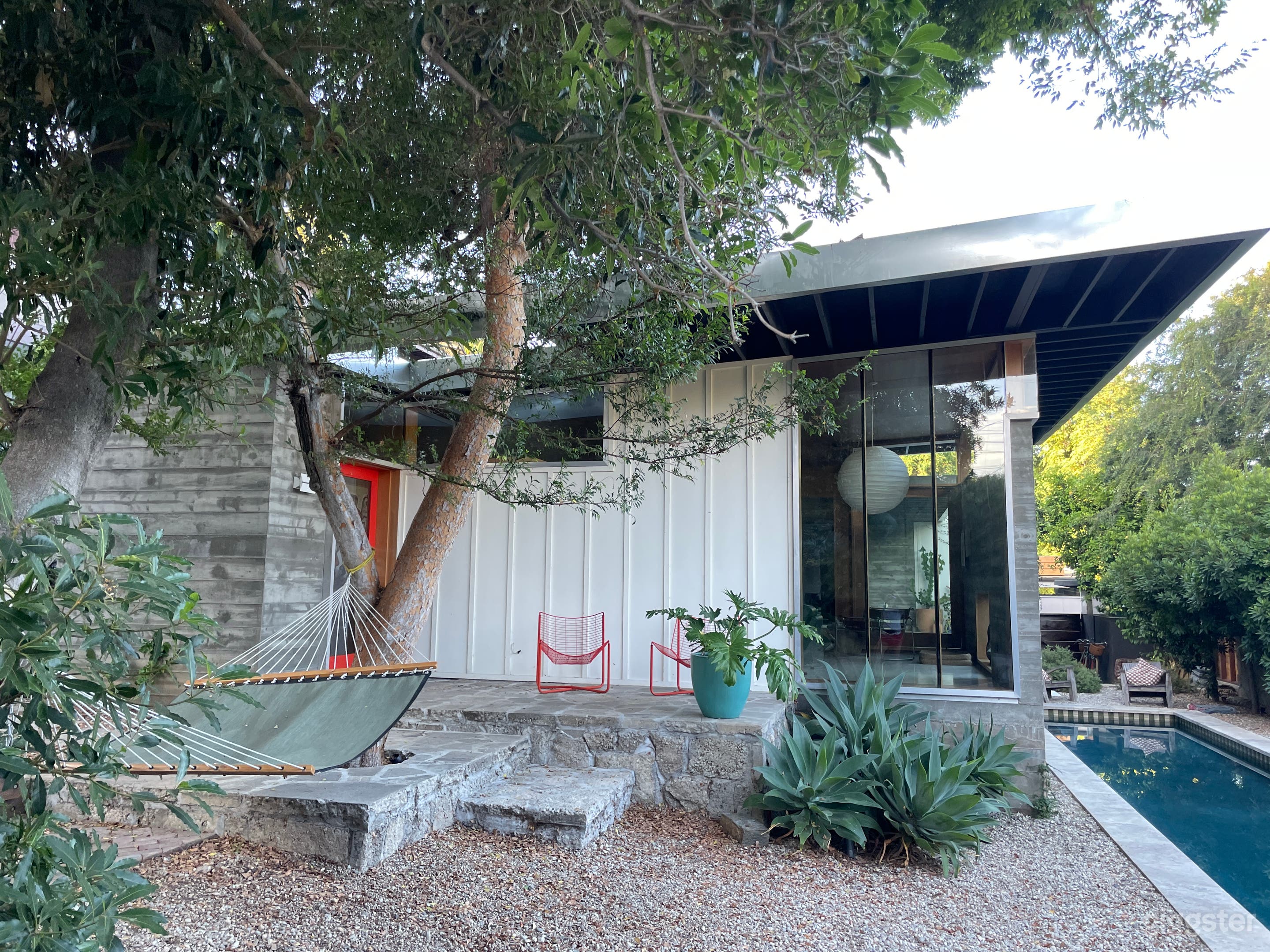 View of front of house with pool on the side. 