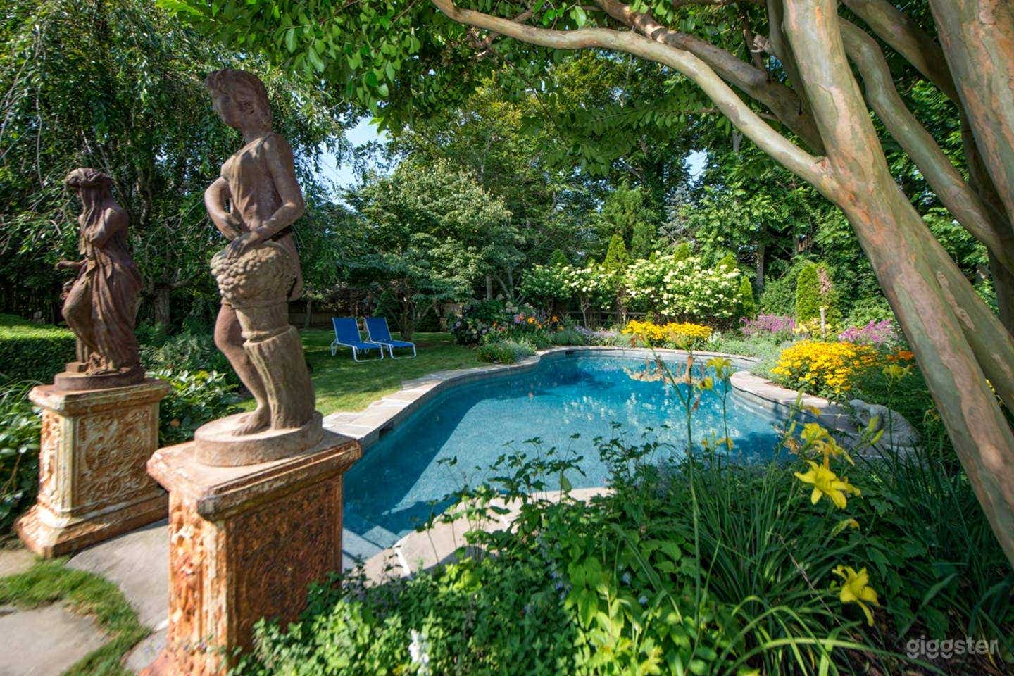 Free-form heated pool with surrounding English gardens