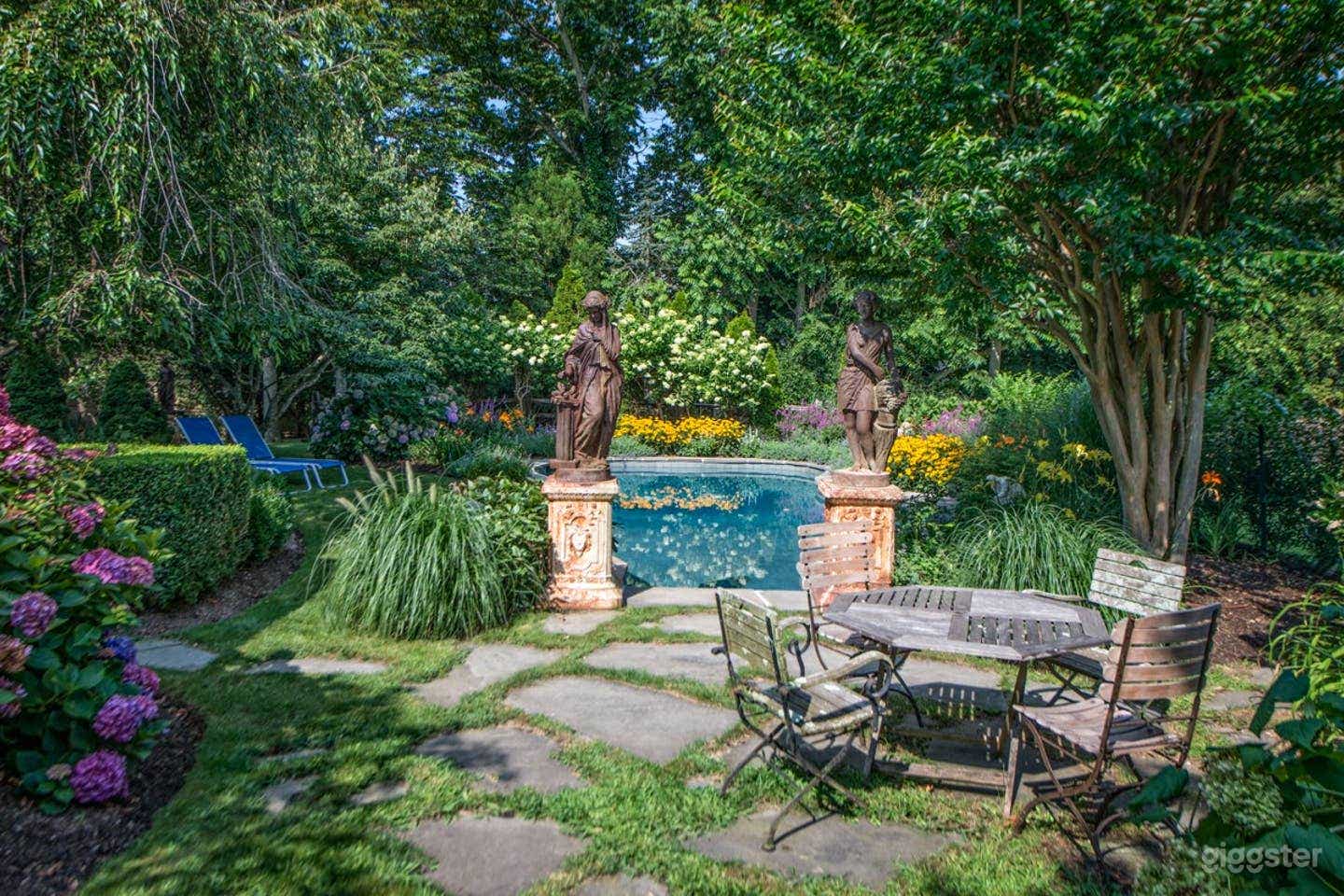 Free-form heated pool with surrounding English gardens