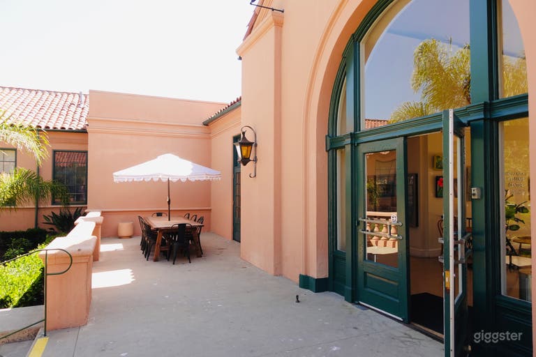 Patio on the back side of the building. One of the two large tables with umbrella. Garden on the left there. 