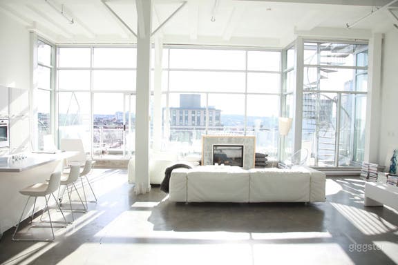 Light filled loft with white high end furnishings.