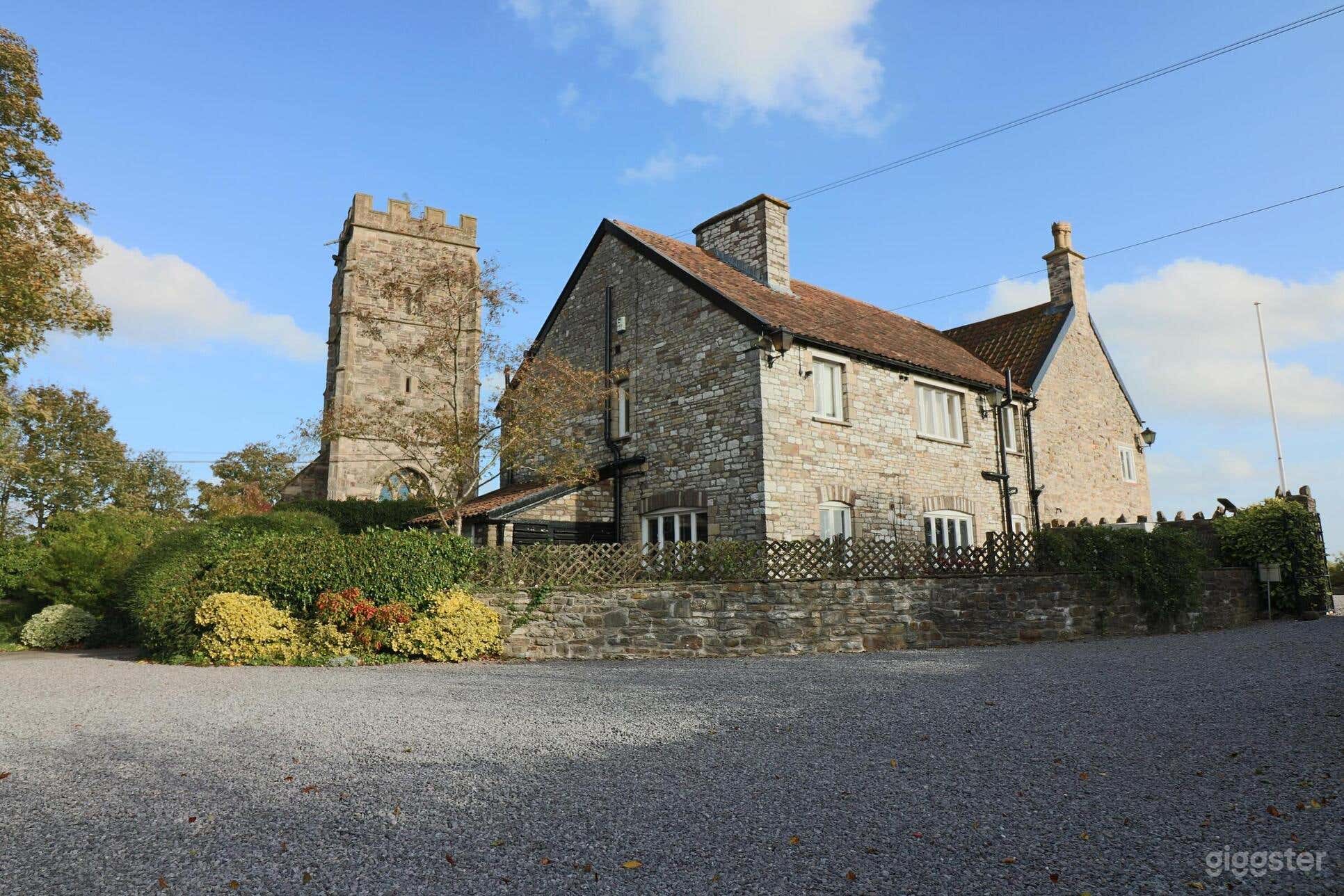 North West aspect showing extension. The 12th Century church tower is to the left.