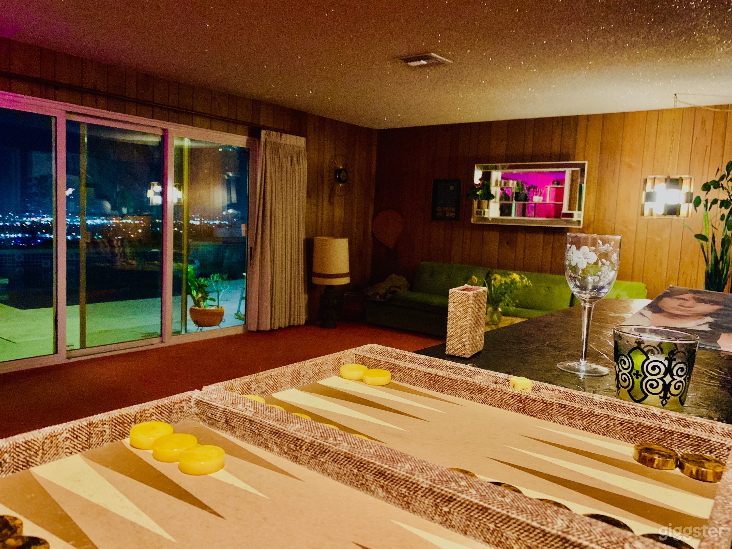 Sunken den with full wet bar and view of the pool and city lights.