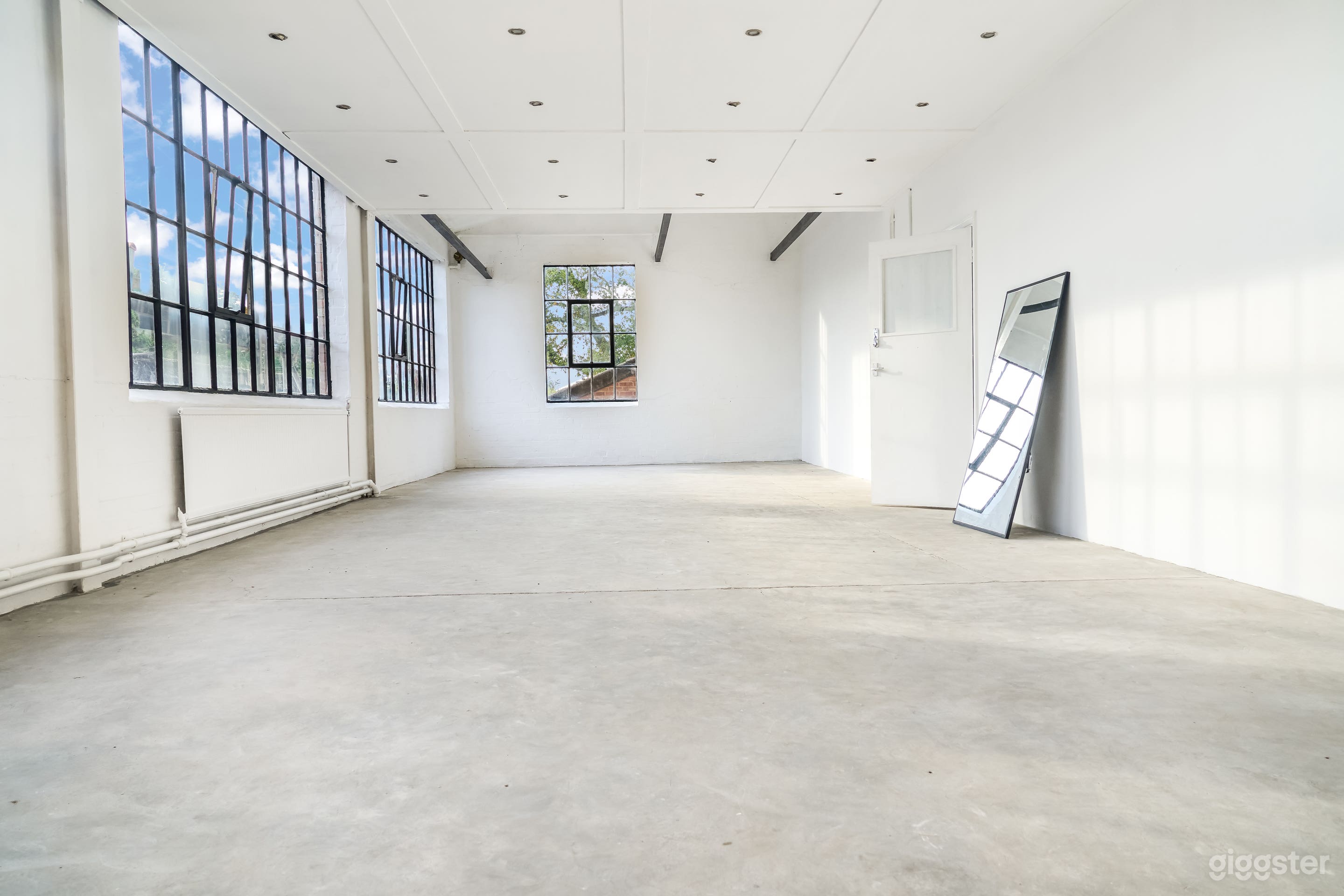 Bright Industrial Photo Studio with Natural Light &amp; Minimalist Aesthetic Photo 1