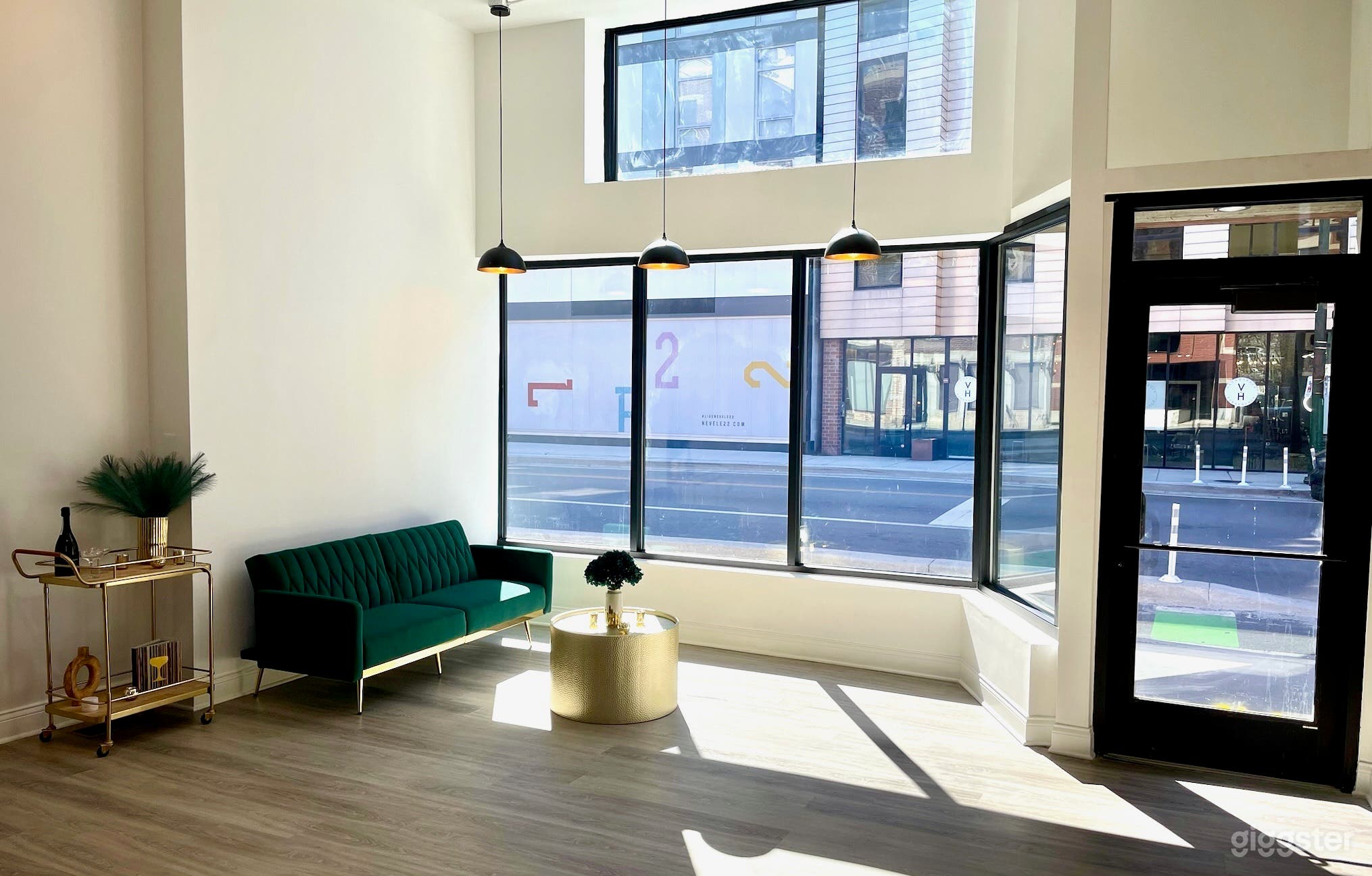 During the day, natural light floods the space through large storefront windows