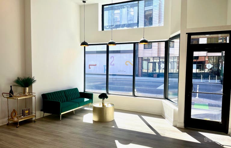  During the day, natural light floods the space through large storefront windows 