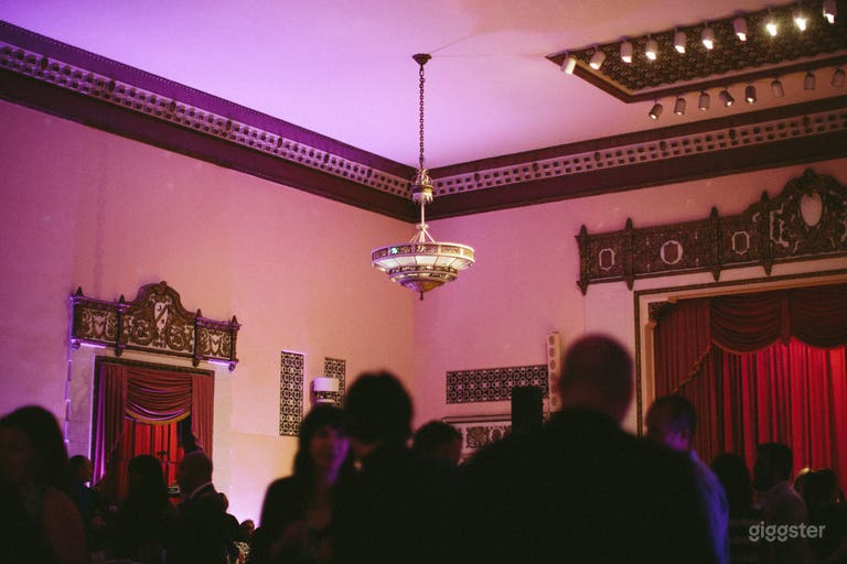  Antique chandeliers hang from a high ceiling. 