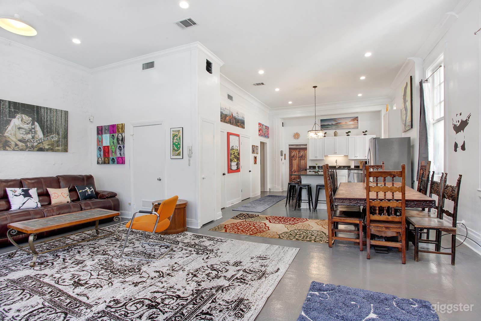 Spacious living dining area with big screen TV and leather sectional