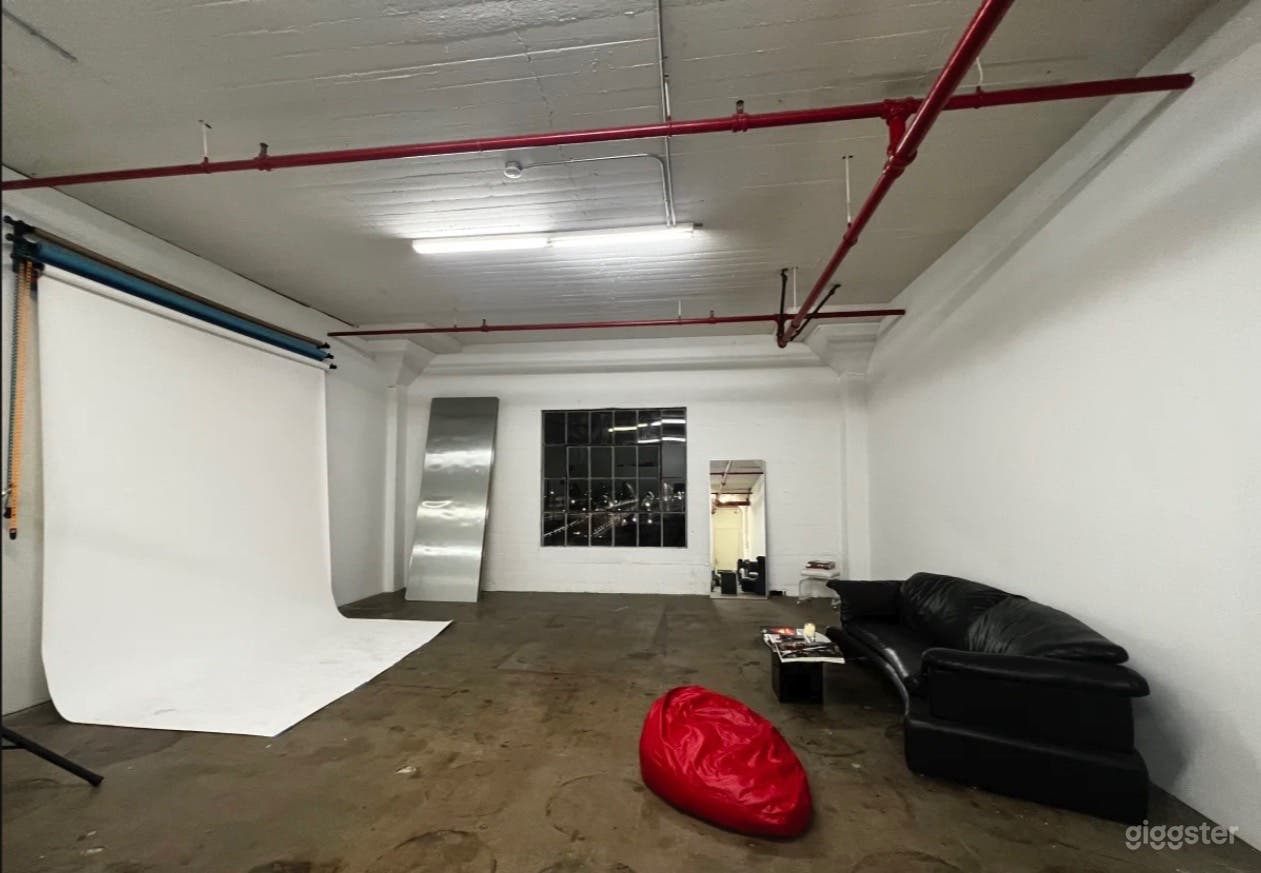 Spacious loft with concrete floors and 18ft ceilings. 