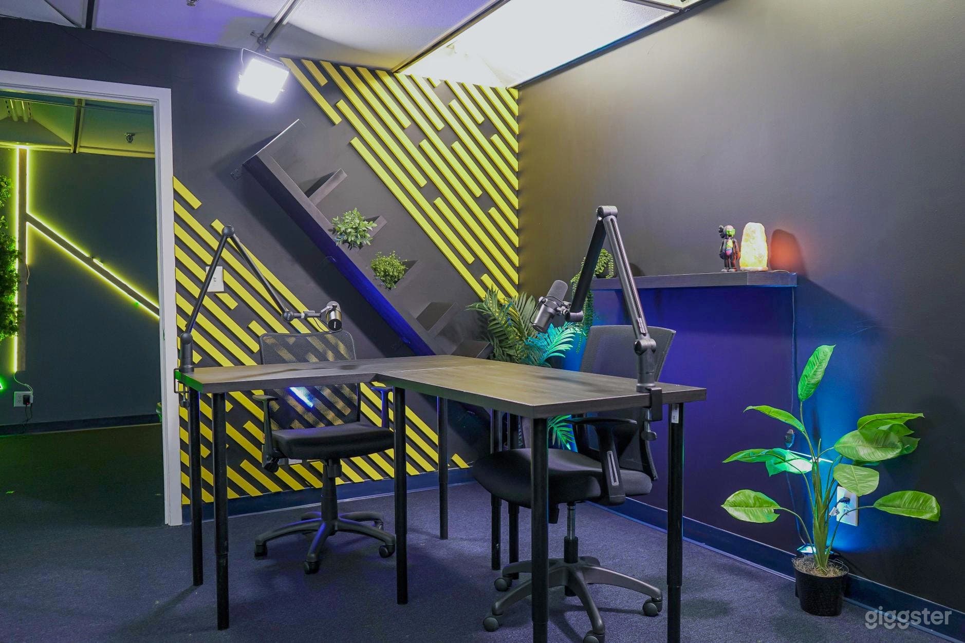 Studio A at Content House Plus: A dynamic space combining sleek black walls with vibrant yellow accents for a bold, creative vibe. Featuring professional lighting and extensive shelving for gear, it's an ideal setting for diverse, high-energy projects. 