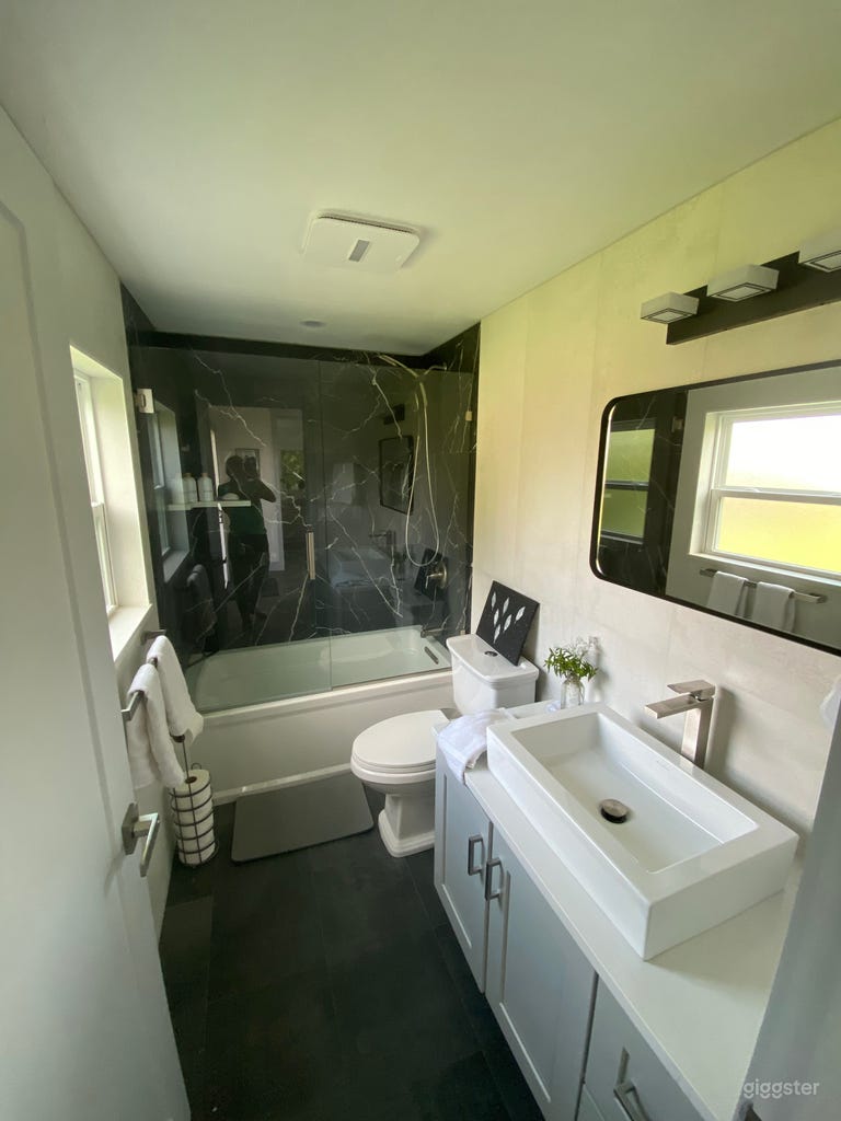  Full bathroom with modern floor to ceiling tile 