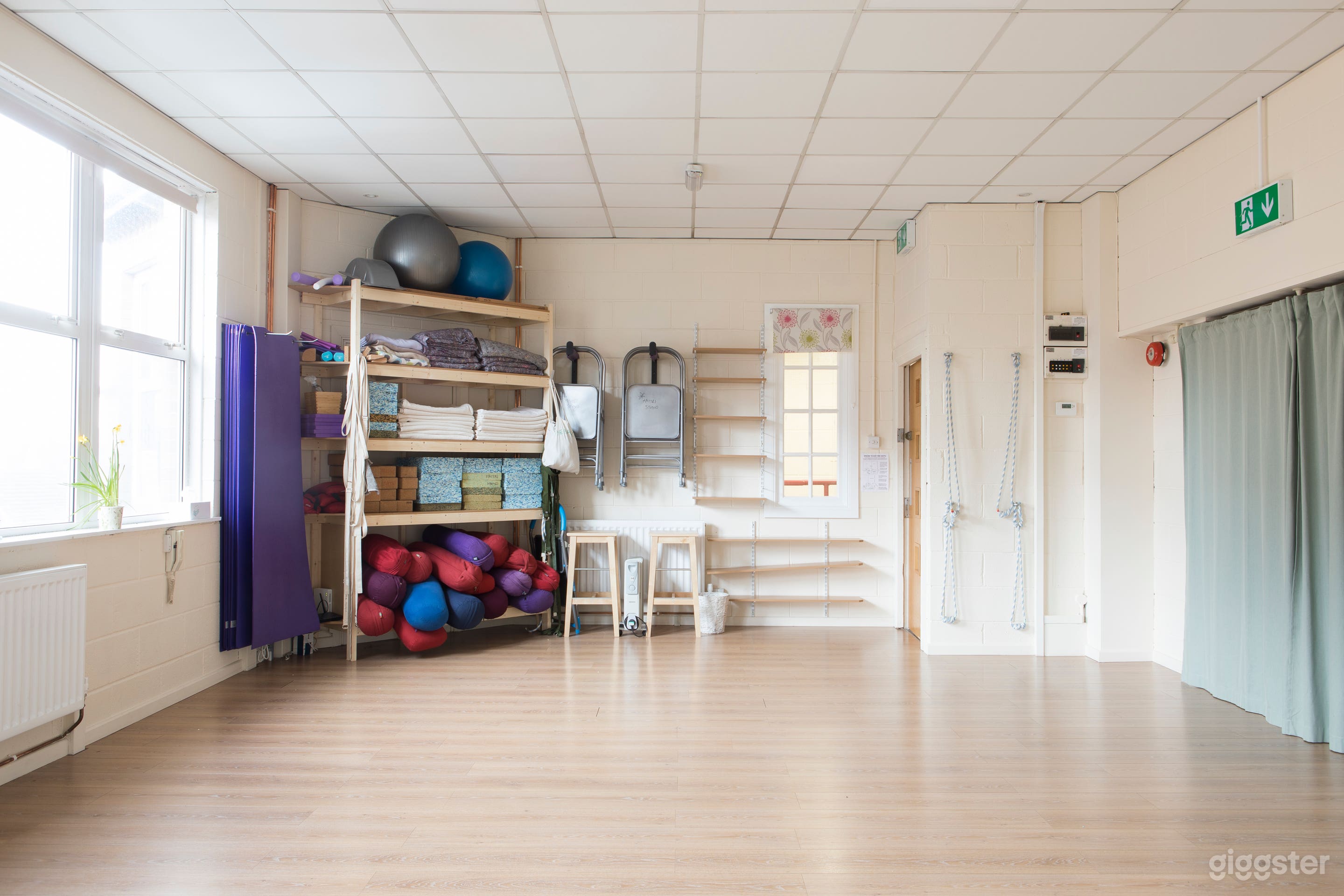 View to end showing equipment storage shelves and curtains over doors to adjacent Maple room.
